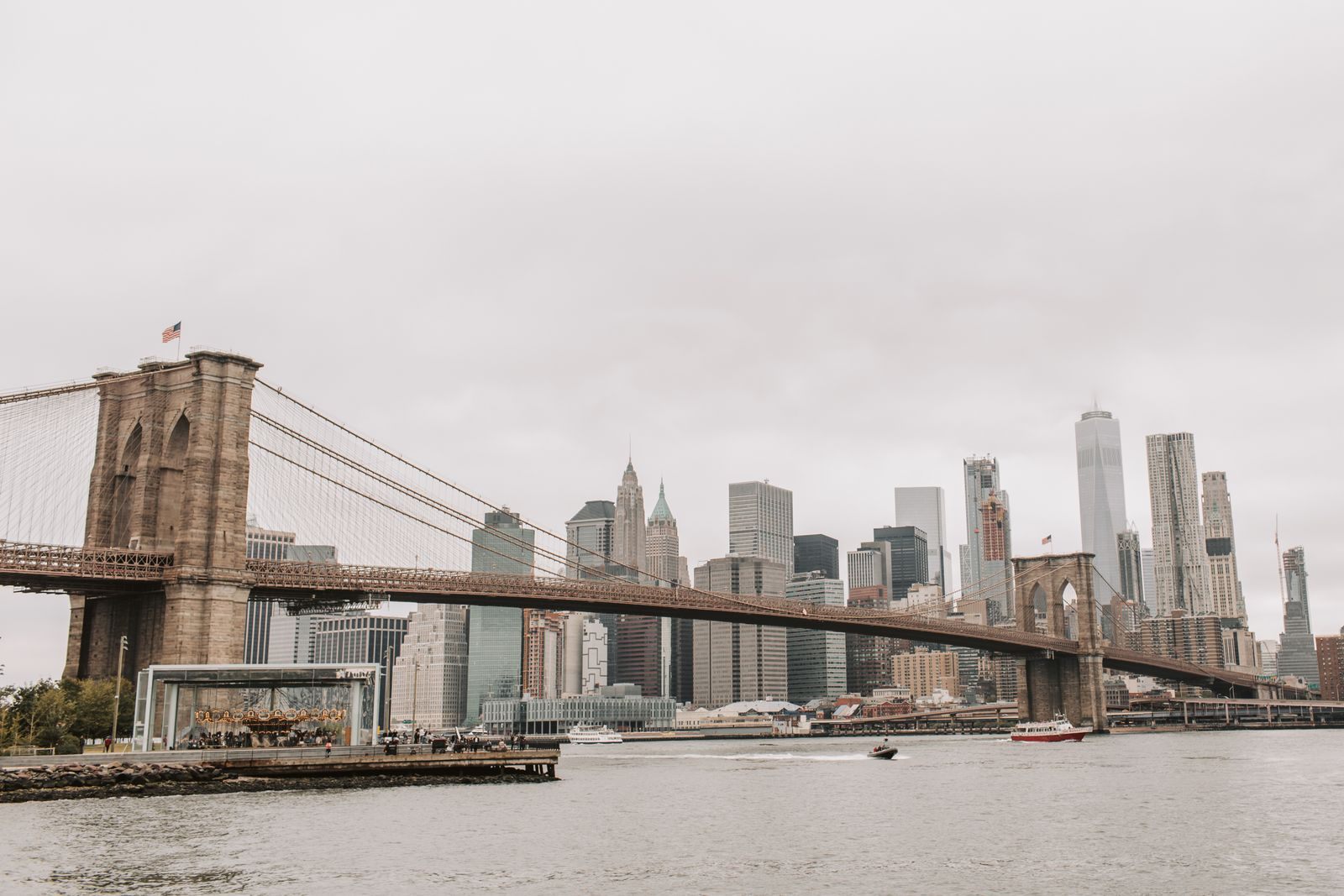 The Brooklyn Bridge stretching across the East River toward the Lower Manhattan skyline